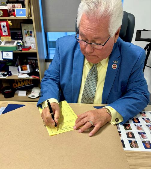 Sen. Archuleta signing a bill for introduction.