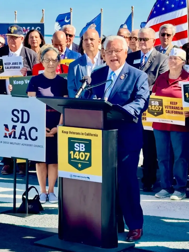 Senator Bob Archuleta is pictured (center at the podium) with his colleagues and veterans and their families speaking on his legislation.